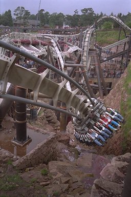 Riders come dangerously close to the pools of blood on Nemesis, with the twisted track in the background.
