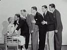Genevieve Tobin assesses the kissing technique of: (l-r) Roland Young, El Brendel, Ralph Forbes, Raoul Roulin, and Victor Jory, March 10 1933