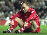 England International Danny Murphy sists on the pitch in shock at the result.