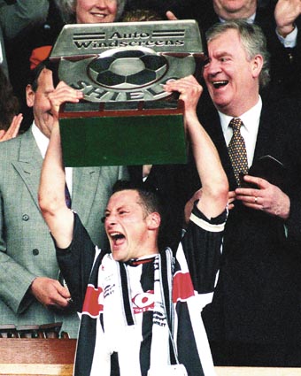 Town skipper Paul Groves lfts the Auto Windscreen Shield to the cheers of the Town fans.