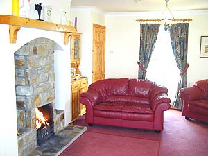 The lounge - the open fire provides a focal point adding warmth to the ambience