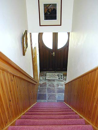 Front door and entrance hall viewed from landing