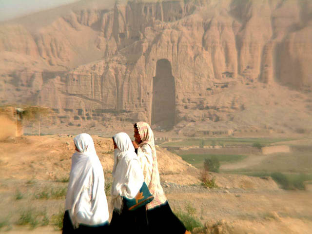 Girls in front of empty Buddha caves, Bamiyan, Afghanistan