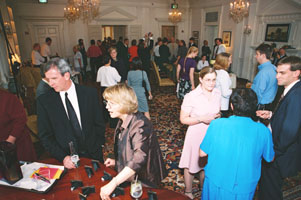 bruce and gloria scoping out the little pictures on the piano, while caroline and joe talk with diane...&nbsp; hi stan and traci!