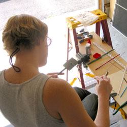 shaping my molten glass (wrapped around the mandral) on a slab of graphite