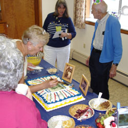 nita cutting the cake!&nbsp; chico and grandad look on....