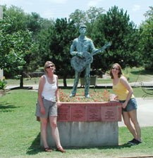 mom & bec at the woody guthrie statue...no stoplights in town, but they have a woody guthrie statue&nbsp; :D&nbsp; as well it should be
