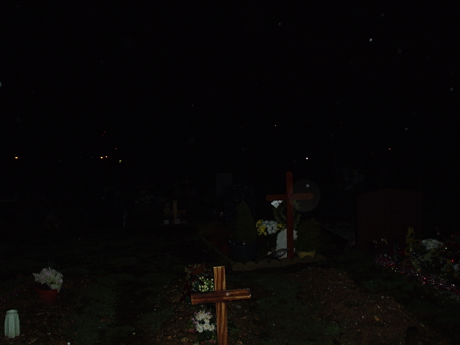 This one was taken at out local graveyard. We were sat down and thought yeah come on lets go up there although there is a funny story to it as we got looked in and had to ask this man to open the gates and then got pulled over by the poilce! they wondered what we were doing lol. Prob thought we were right weirdos. Its above the headstone, you see it?