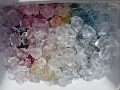 Ice dye in a small bucket, ice is covering the dye