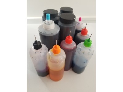 Different sized bottles of liquid dye