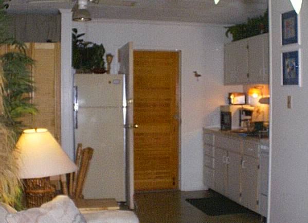 large kitchen area with outer louvered door