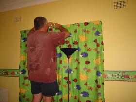 Dad puts up the new curtains
