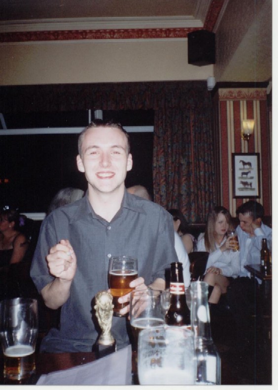 Gareth grinning in drunken glee over his trophy.