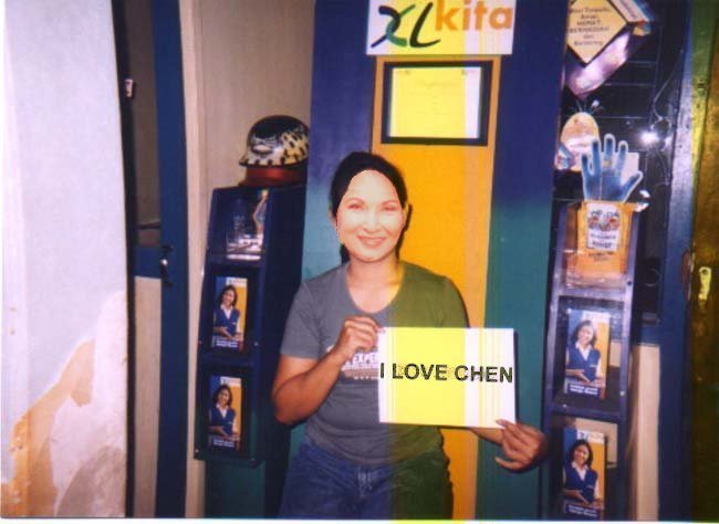 Ima holds up a sign for slimy little Chen