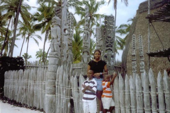 Me and the brats in front of an old tiki village