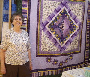 We honored and highlighted Sis Scheffer, shown here with her latest round robin quilt