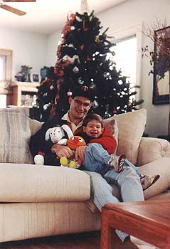 Craig and Maxwell on the couch at Christmas time