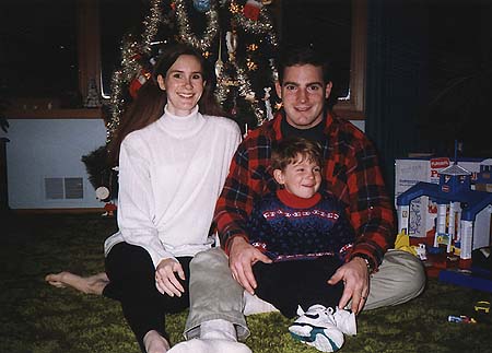 Christmas 1993 - Craig, Kimberly and Maxwell sitting on the floor in front of the tree