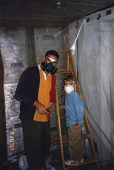 September 1995 - Craig and Maxwell wearing dust masks working on basement walls