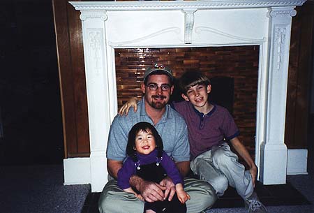December 1999 - Craig, Zoey and Maxwell in front of the fireplace
