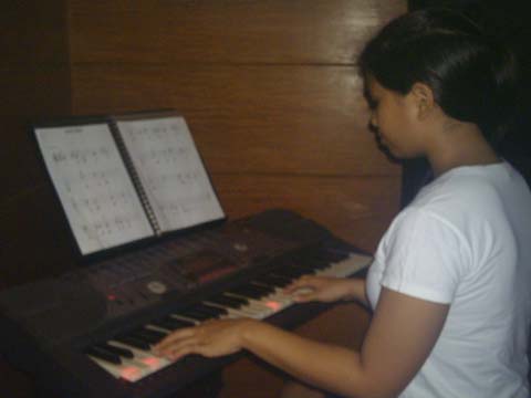 Kristine playing their electric piano