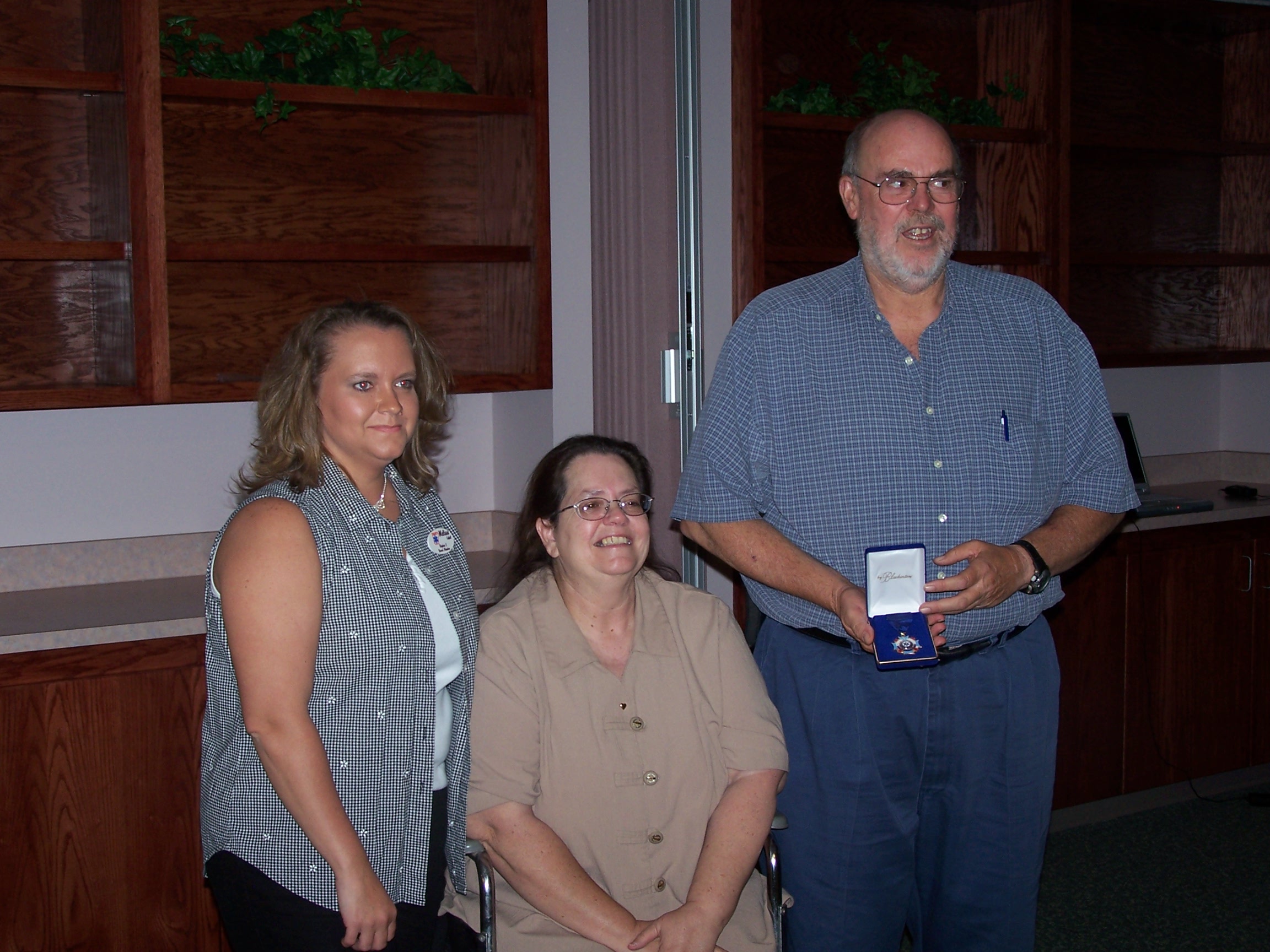 Melissa Coffel presents Paul Richardson with the award. Paul's wife Suzie is by his side.