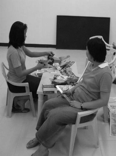 Cutting and preparing the visual aids which will be mounted on the walls of the classrooms.