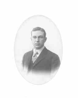 
Fred (from chest up) in suit, tie and glasses
