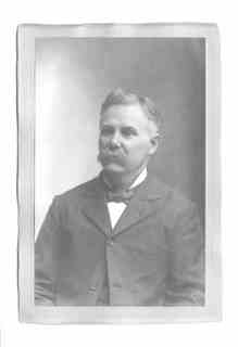 
Issac (from chest up) in suit, bowtie, and mustache (portrait format)
