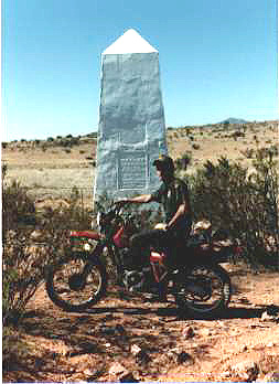 Background depicts a border monument