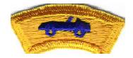 Features a model royal blue car on a gold background. Worn by Cub Scouts and Leaders participating in a Pack-sponsored model racing car competition.