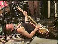 Tracy Lea Landis playing bass in a deep back bend Feb 5 2000
