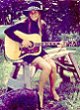 Tracy Lea Landis with blue tick coon hound, guitar and Buffy Saint Marie hat