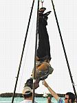 Bound in chains and a straight-jacket this guy escapes while hanging upside down.&nbsp; Houdini did this trick while under water!