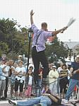 Juggling swords while tight-rope walking over a "volunteer"