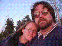 Nora and Curt overlooking Lake Superior at the beach at MacClain State Park during sunset