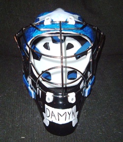 Front of the mask, with a nameplate on the bottom, done in block script.