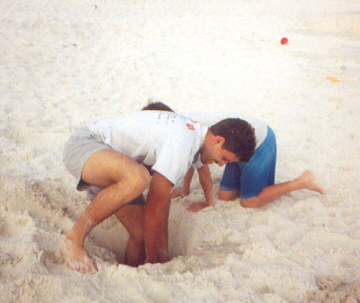 Jerry and James digging a huge hole on the beach