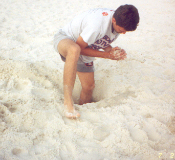 Jerry standing in the hole they were digging on the beach