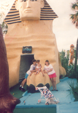 Jerry,James, Joshua and Marie sitting on the sphinx at the miniature golf course