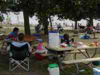 Parents kick back at the beach while the kids go swimming