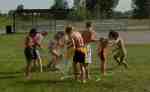 Hoops substituted for chairs and a sprinkler substituted for music in this "Musical Chairs" variation