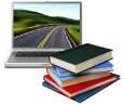 [stack of books in front of laptop]