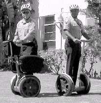 Traffic services manager Don Williams and traffic patrolman Orlando Imperial test out the Segway recently in the courtyard of City Hall. The devices may be used to replace traffic cars.