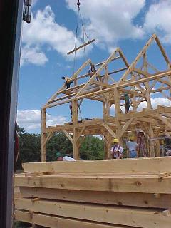 Purlins are lifted and dropped into place, two at a time