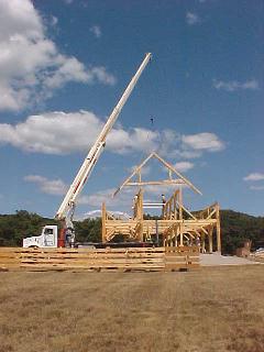 First rafter truss being lowered into place