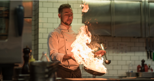 chef with flaming wok