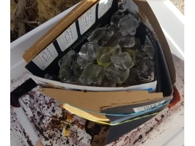 Ice dye with cardboard wrapped around the fabric with rubber bands to hold the ice