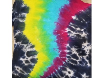 Rainbow tornado ripping through the shirt with a blue/black background.