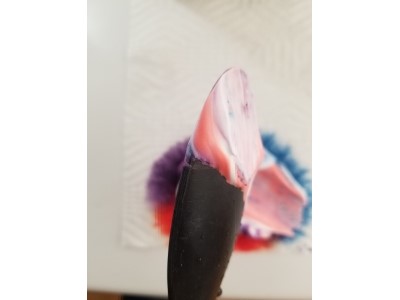Spoon with shaving cream and liquid dye smeared on it
